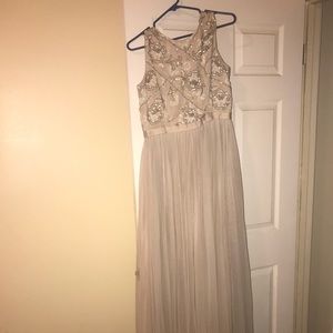 A long, light grayish prom dress.